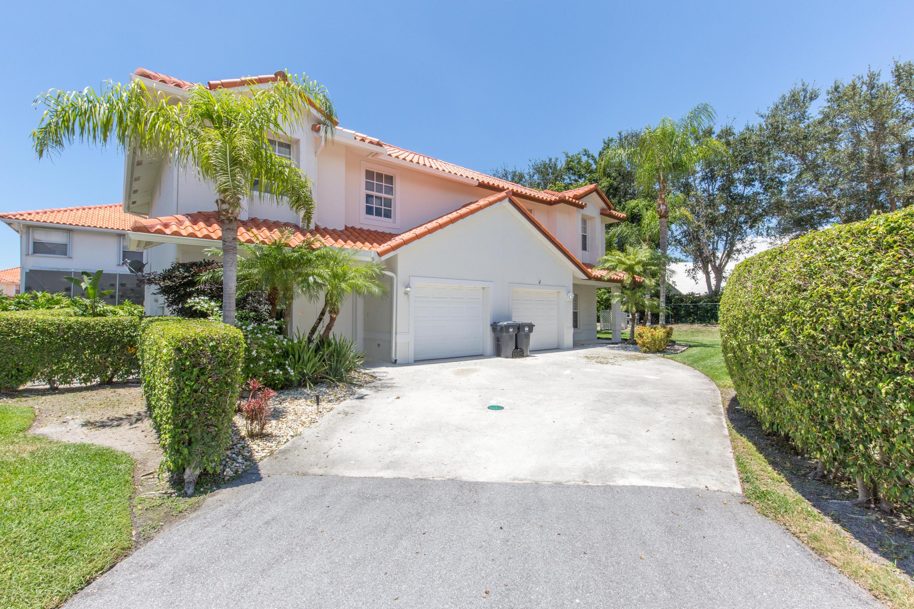 a view of a house with palm trees