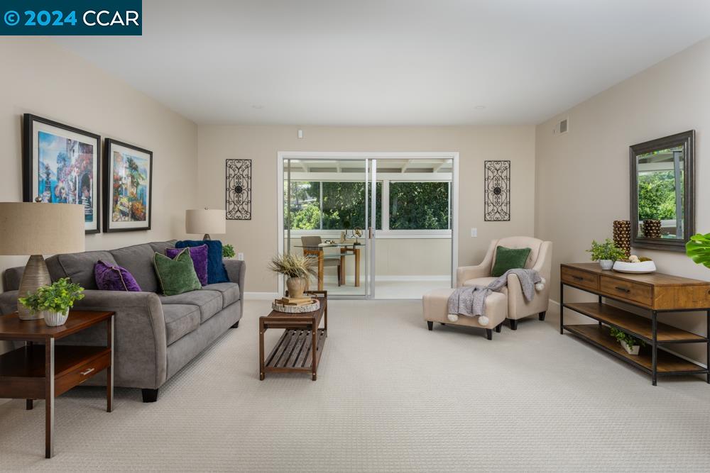 a living room with furniture and a large window