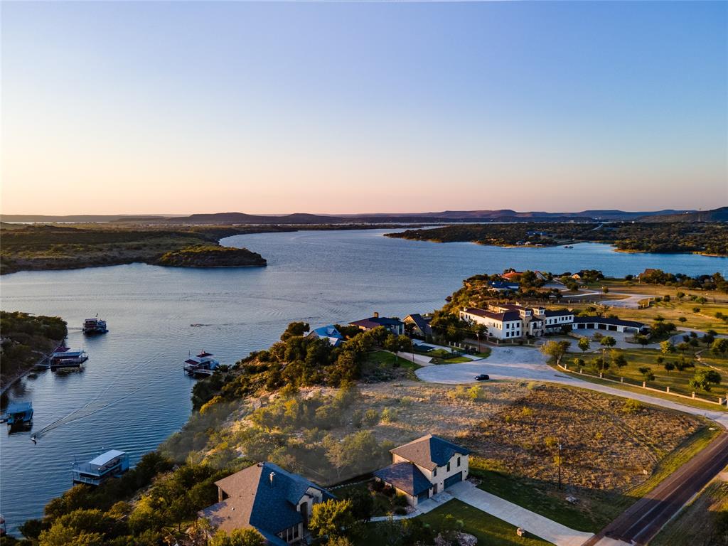 an aerial view of a houses with a lake