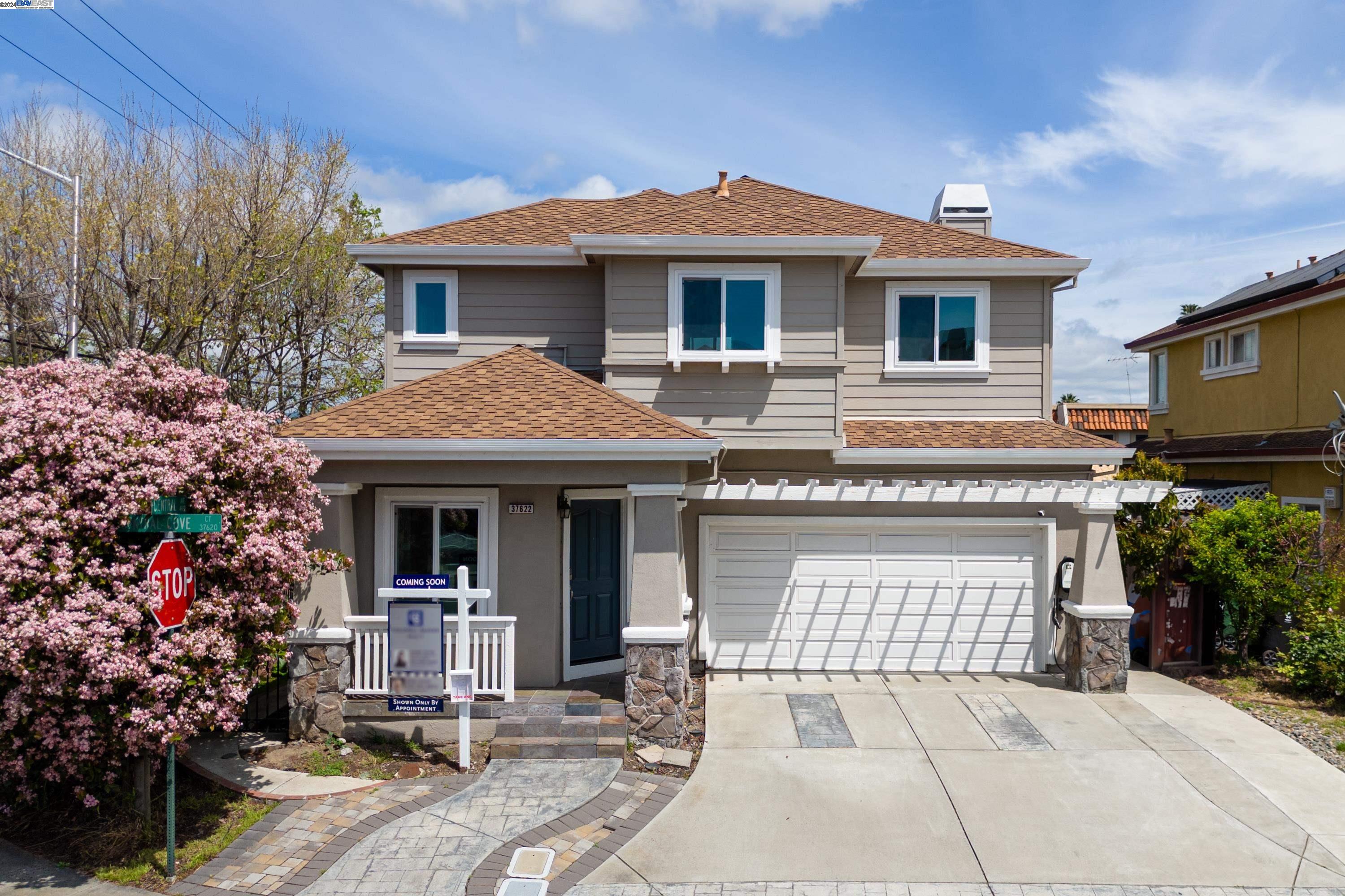 a front view of a house with garden