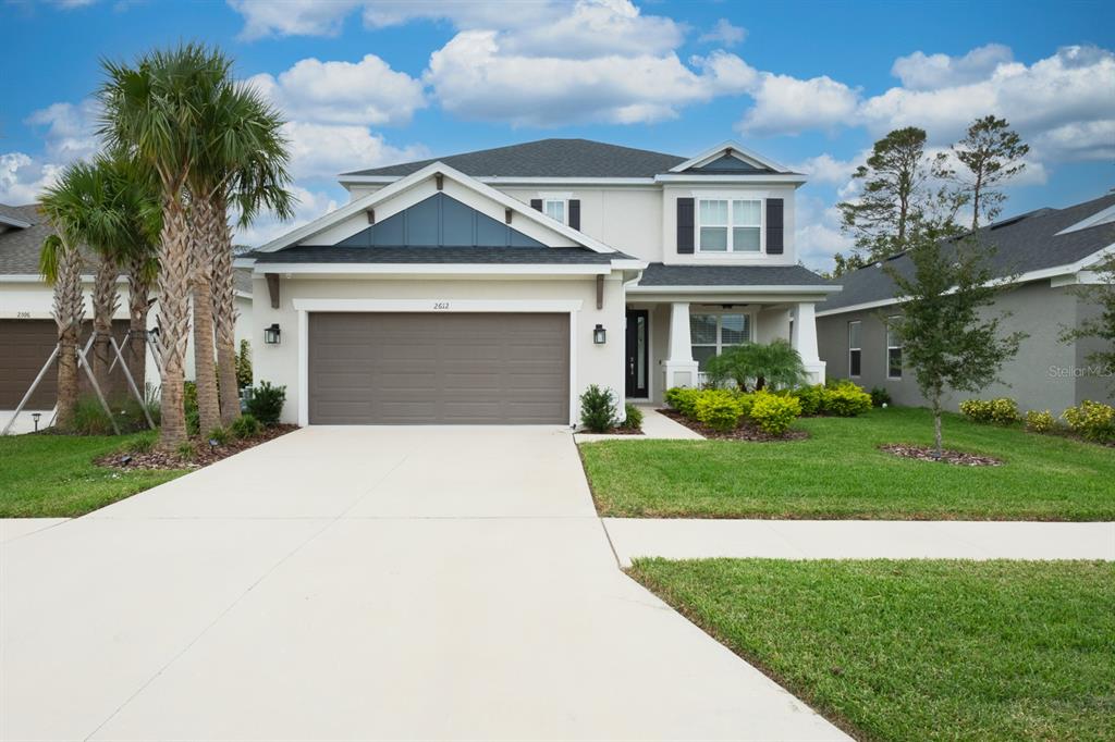 a front view of a house with a yard and garage