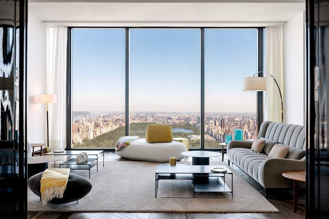 a living room with furniture and floor to ceiling window