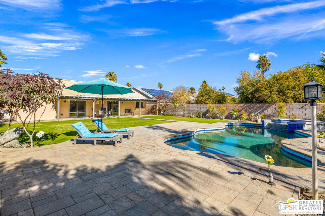 a view of a house with swimming pool yard and a patio