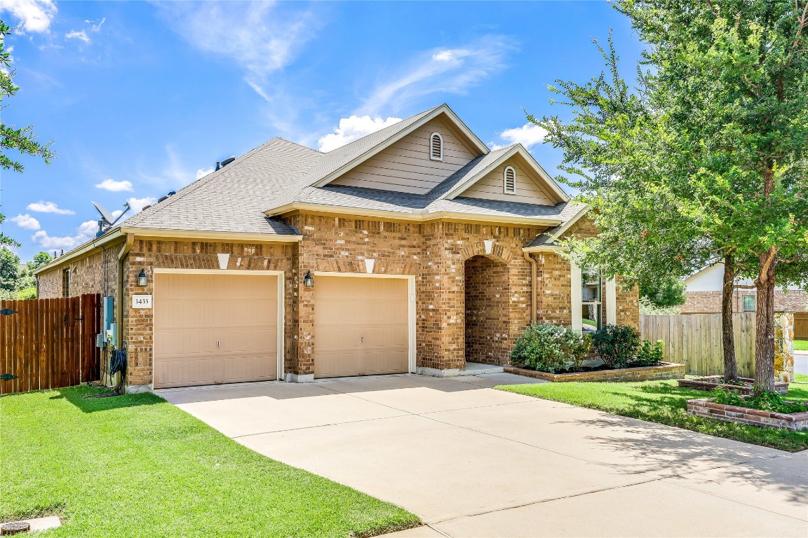 a front view of a house with a yard and garage