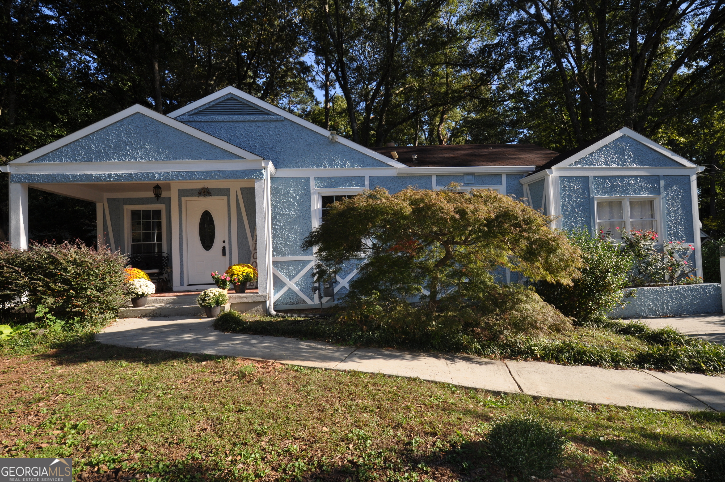 a front view of a house with garden