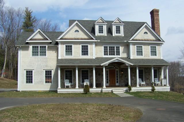 front view of a brick house with a yard