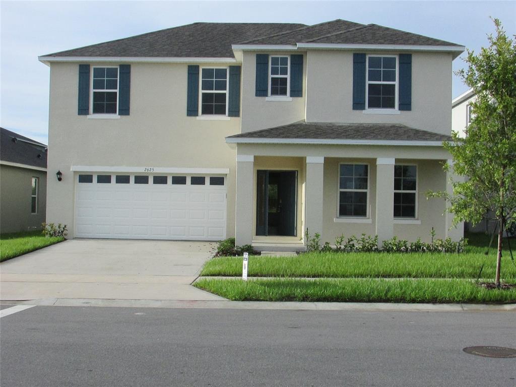 a front view of a house with a garden and garage