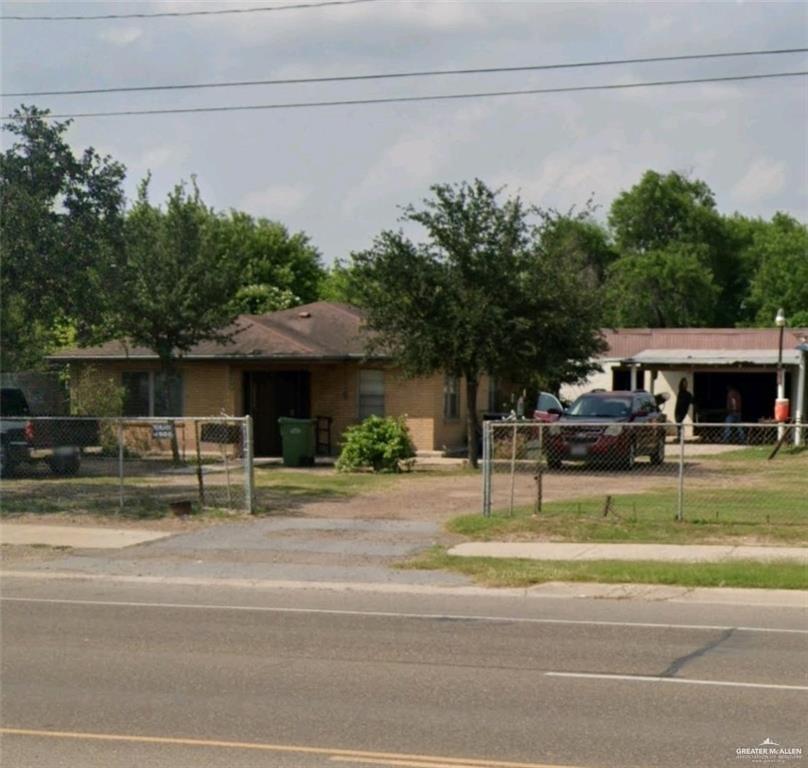 a view of a house with a car parked beside it