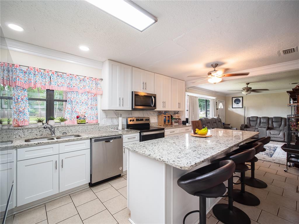 a kitchen with sink cabinets and dining table