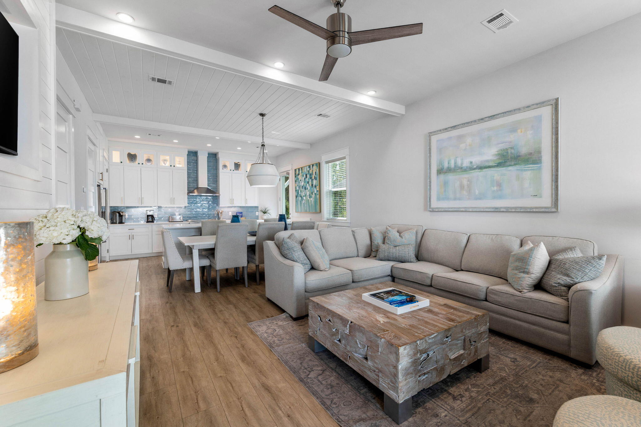 a living room with furniture wooden floor and a flat screen tv