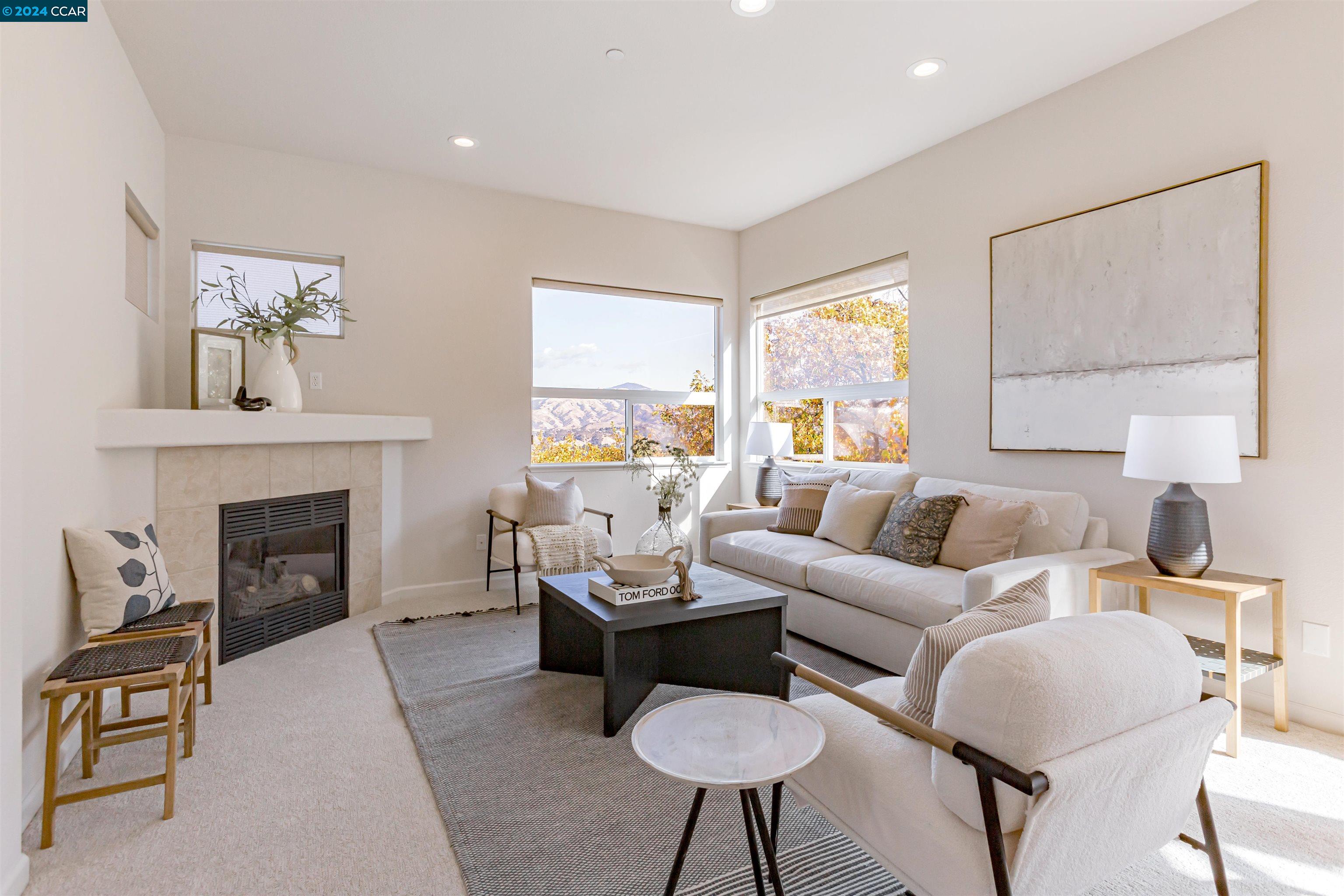 a living room with furniture a fireplace and a large mirror