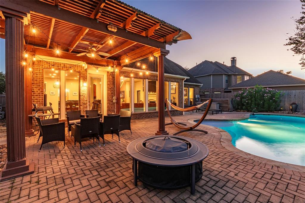 Welcome to West Ranch, a neighborhood with 2 community pools, splash pad, walking trails, parks and lakes. The backyard boasts a covered pergola patio with ceiling fan light fixture. Professionally installed paver decking around the sparkling in-ground pool.