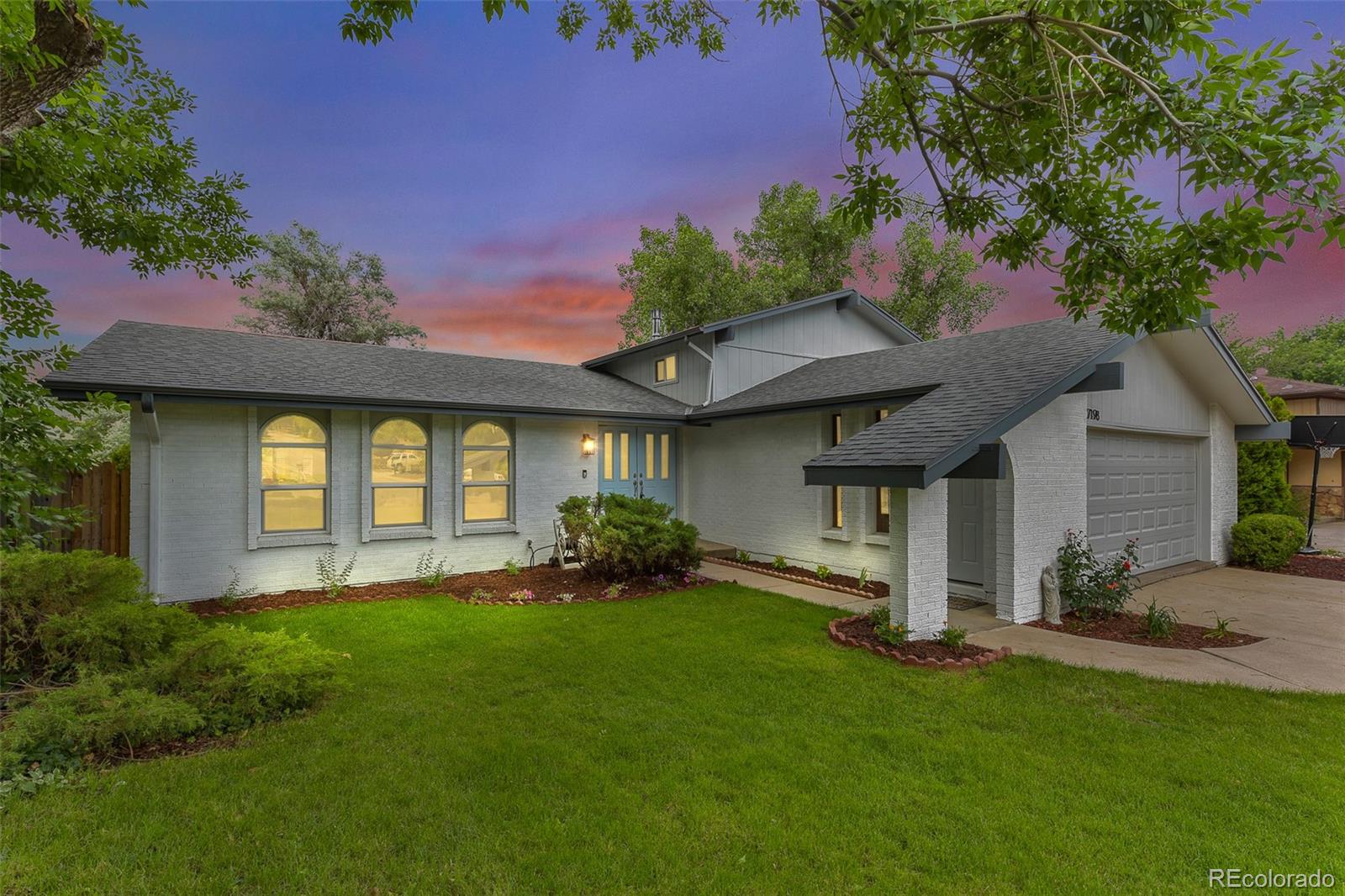 a front view of a house with a yard