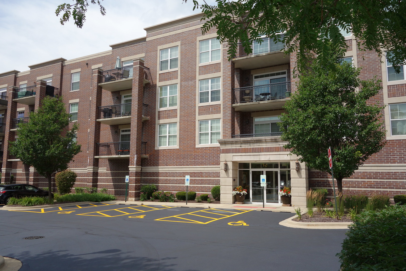 a front view of a multi story building with a yard