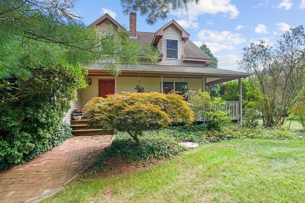 a front view of house with yard and green space