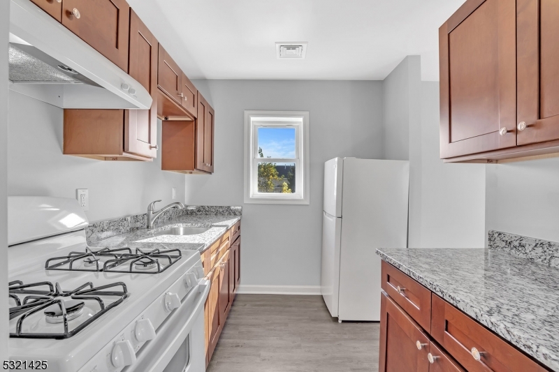 a kitchen with a stove and a refrigerator