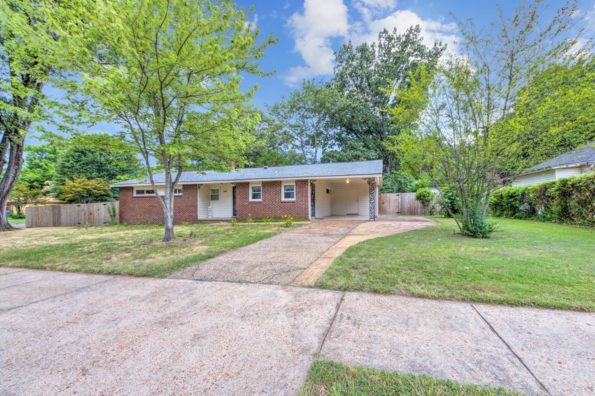 a front view of a house with a yard and a garage