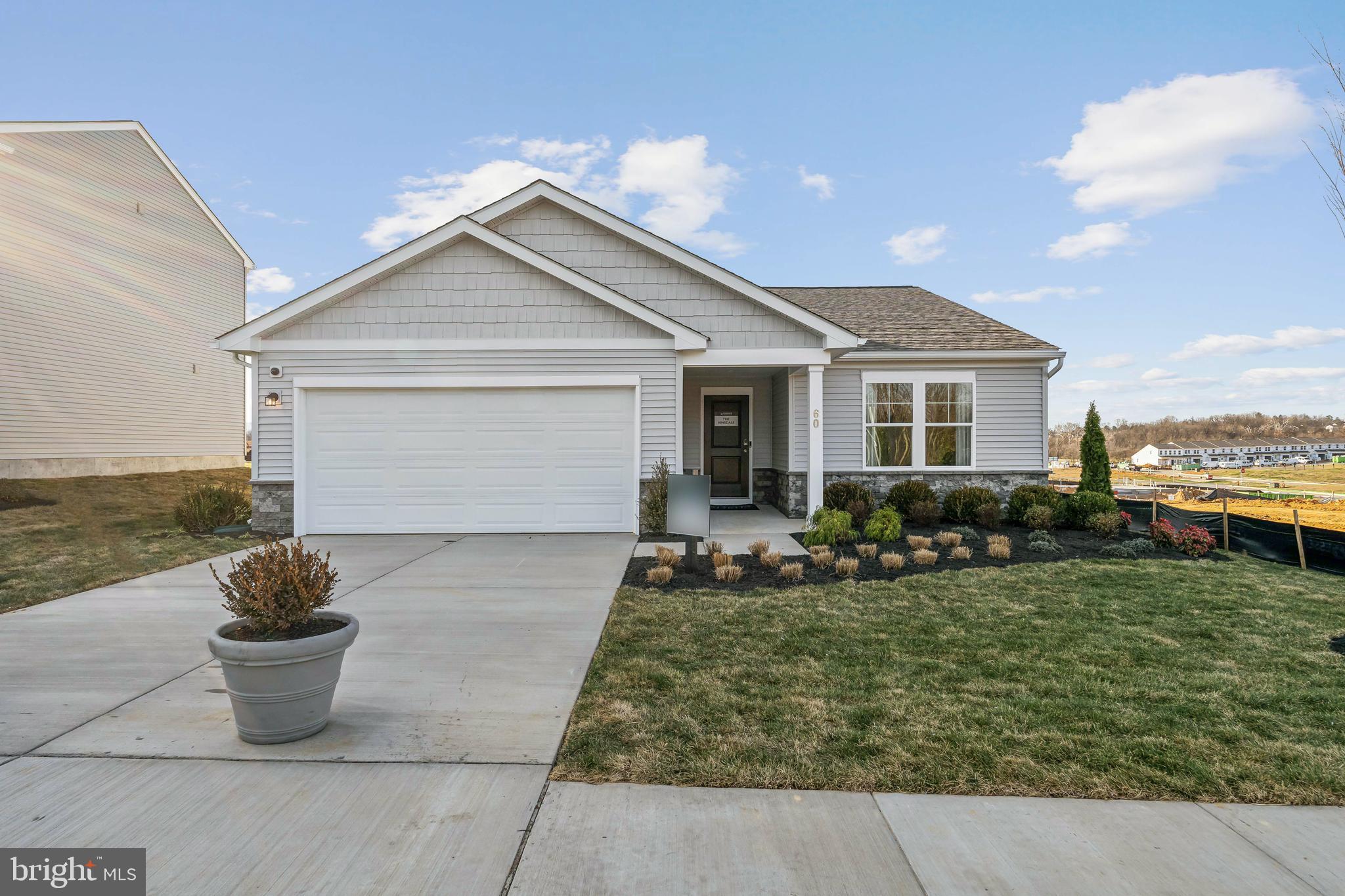 a front view of house with yard and outdoor seating