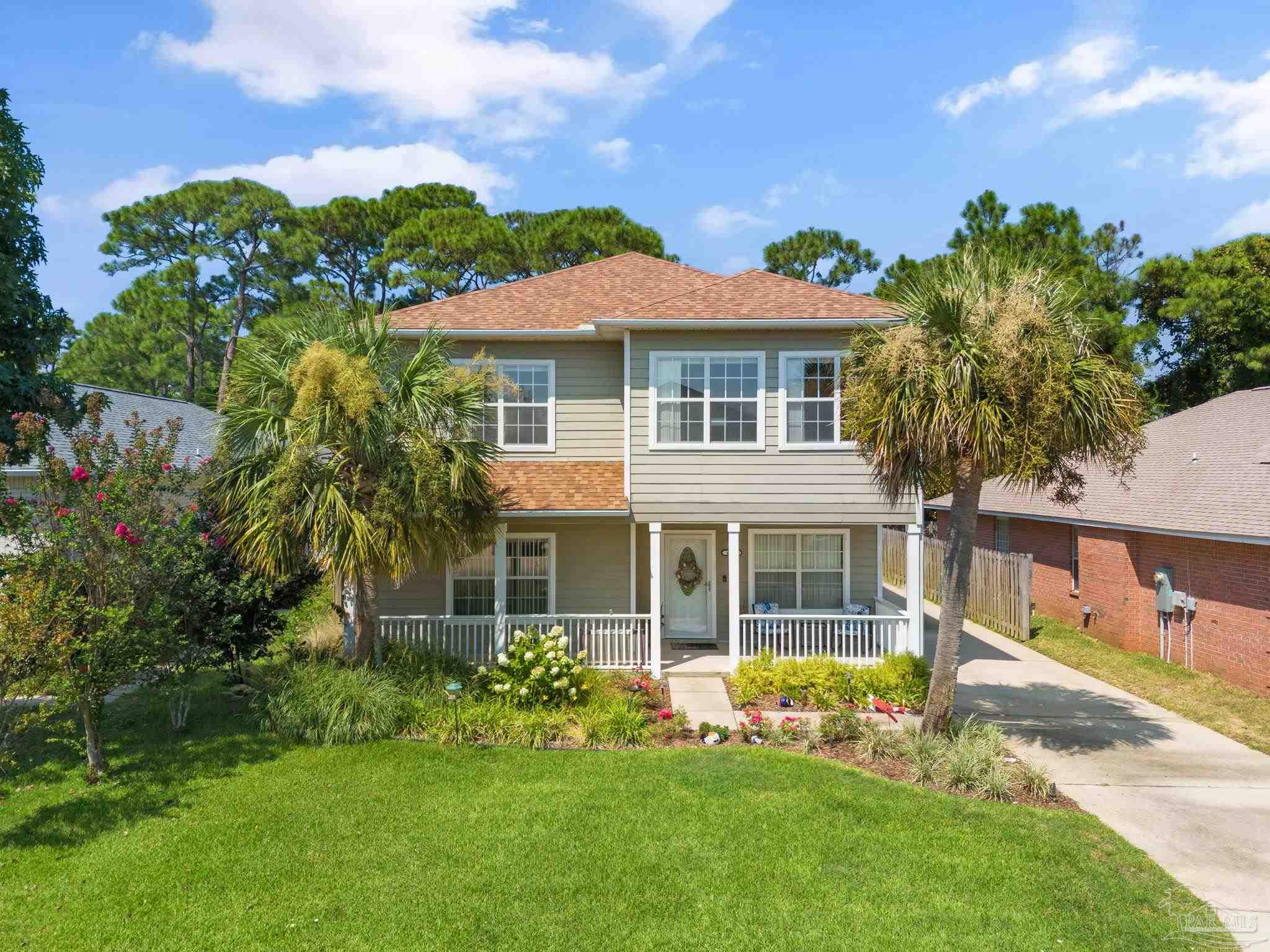 a front view of a house with a garden