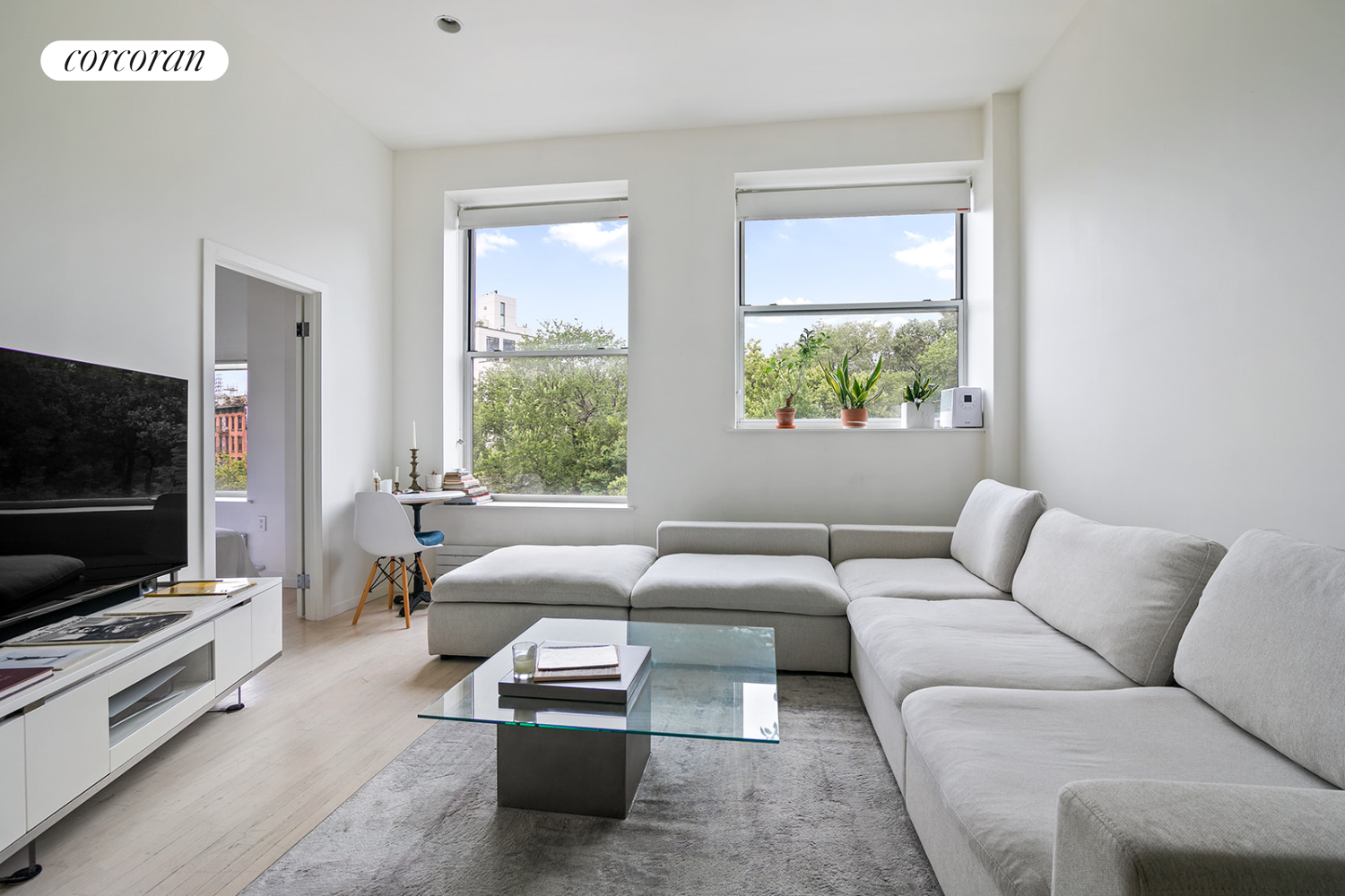 a living room with furniture and a flat screen tv