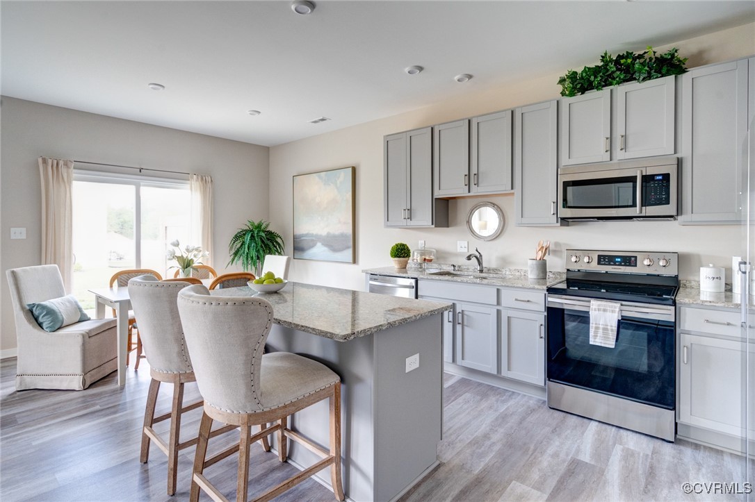 a kitchen with a stove a sink and a microwave