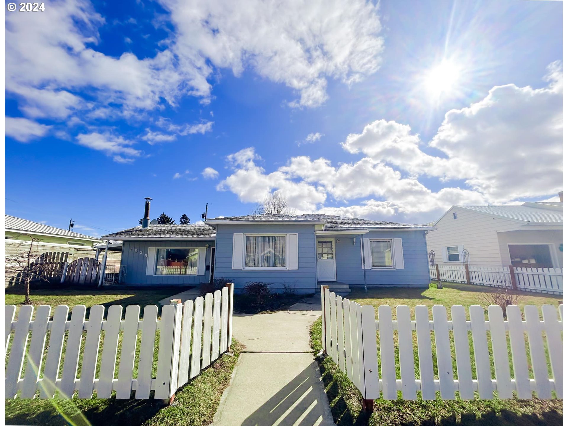 a view of a house with a wooden fence