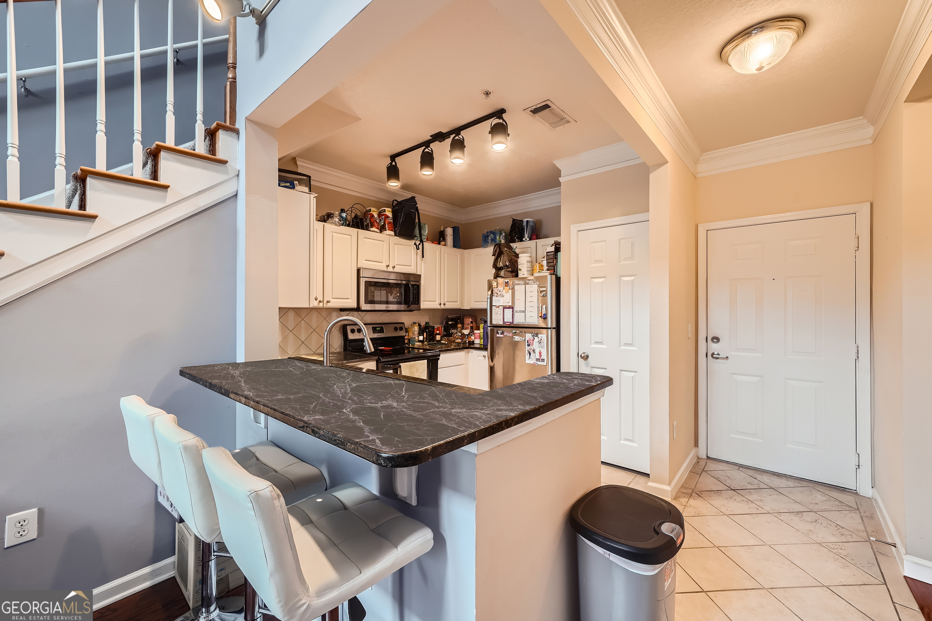 a kitchen with a table and chairs in it