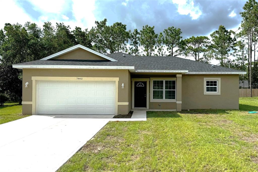 a front view of a house with a yard and garage