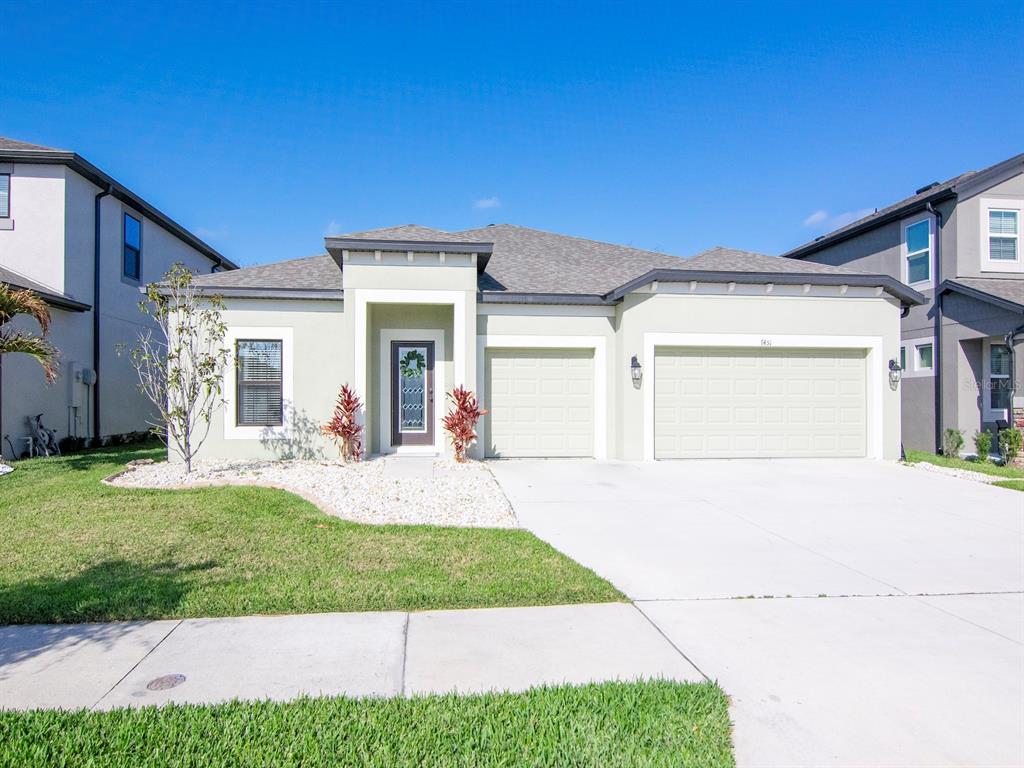 a front view of a house with a yard and garage