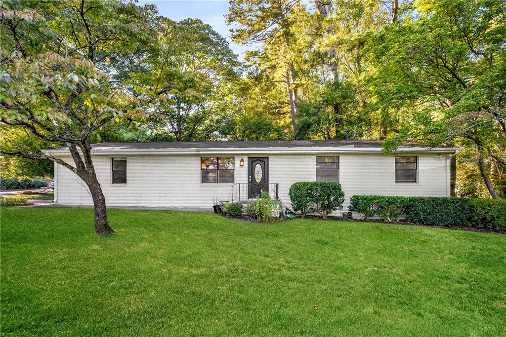 a view of a house with a backyard