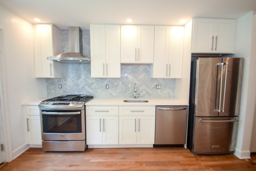 a kitchen with a stove sink and refrigerator