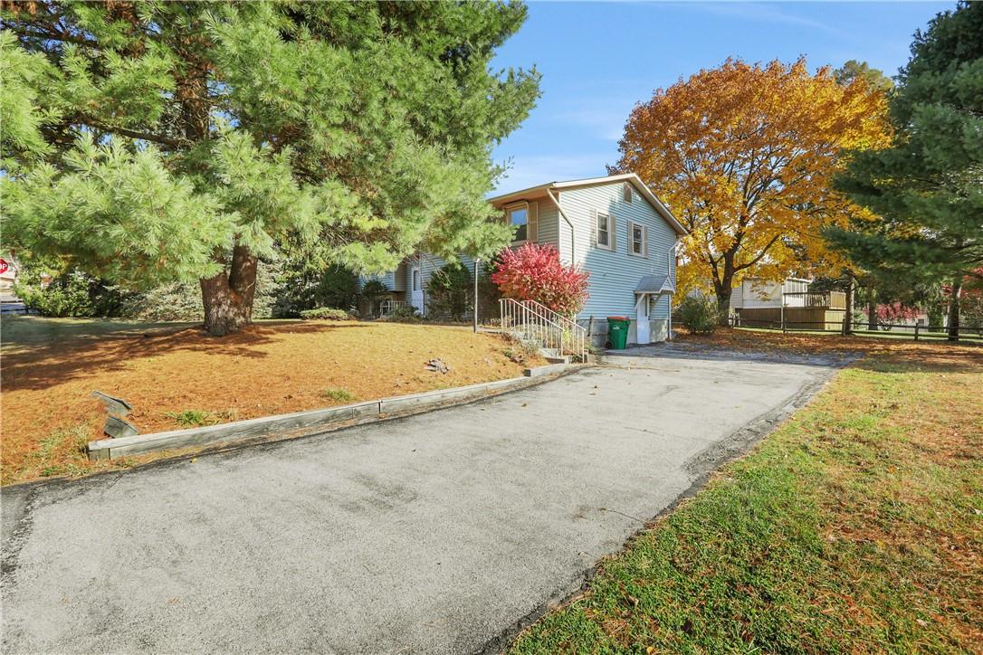 View of front facade featuring a front yard and a garage