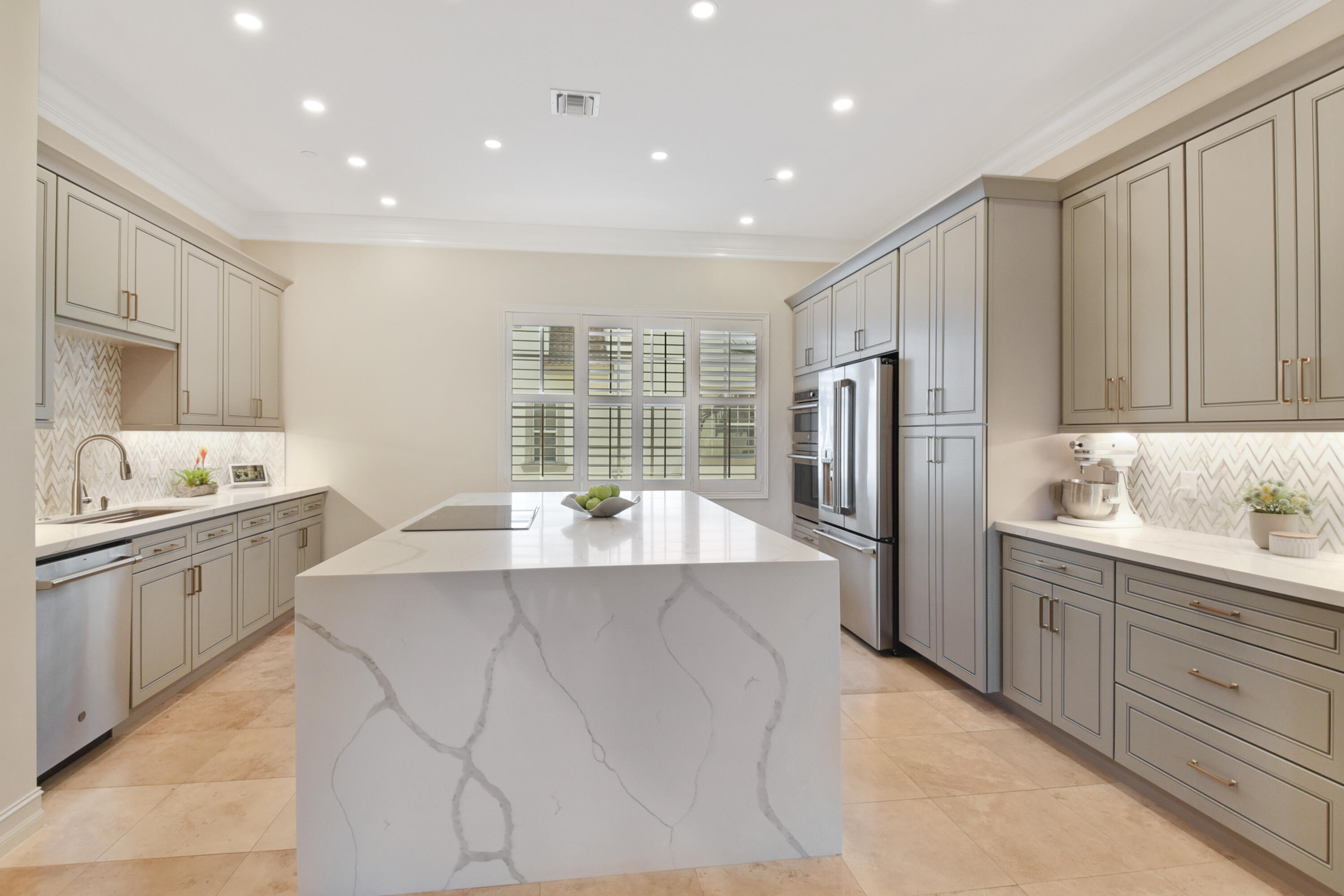 a large kitchen with kitchen island a sink stainless steel appliances and cabinets