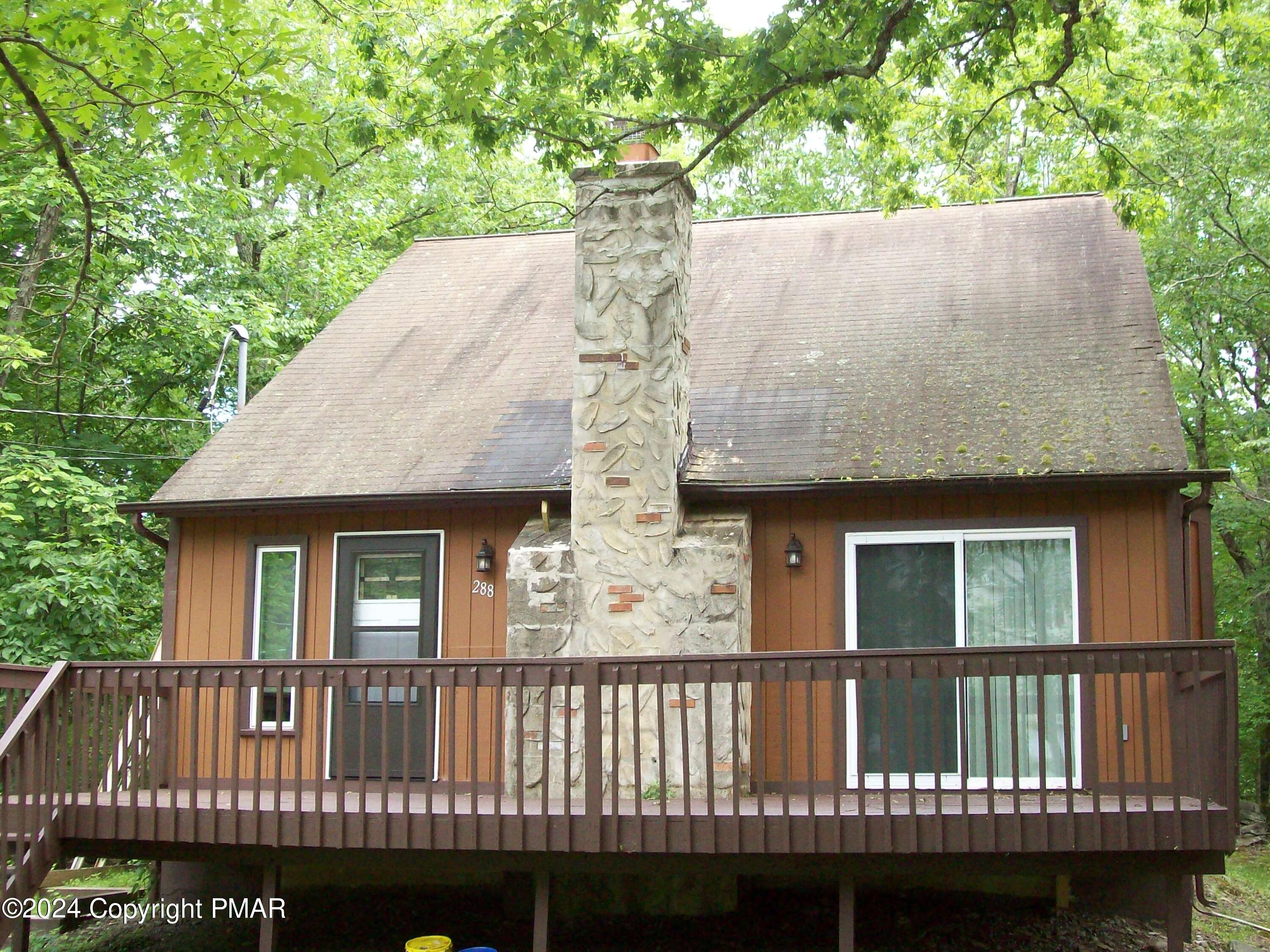 a side view of a house with a garden