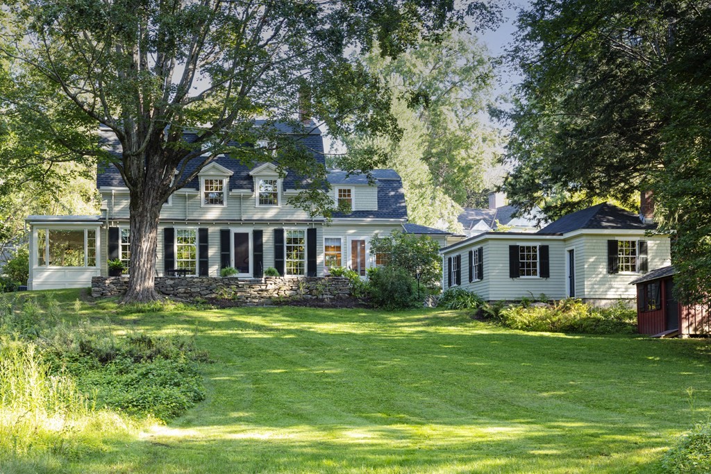 a front view of house with yard and green space