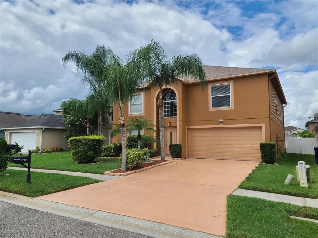 a front view of a house with a yard and garage