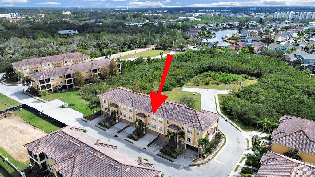 an aerial view of a house with a garden and mountain view