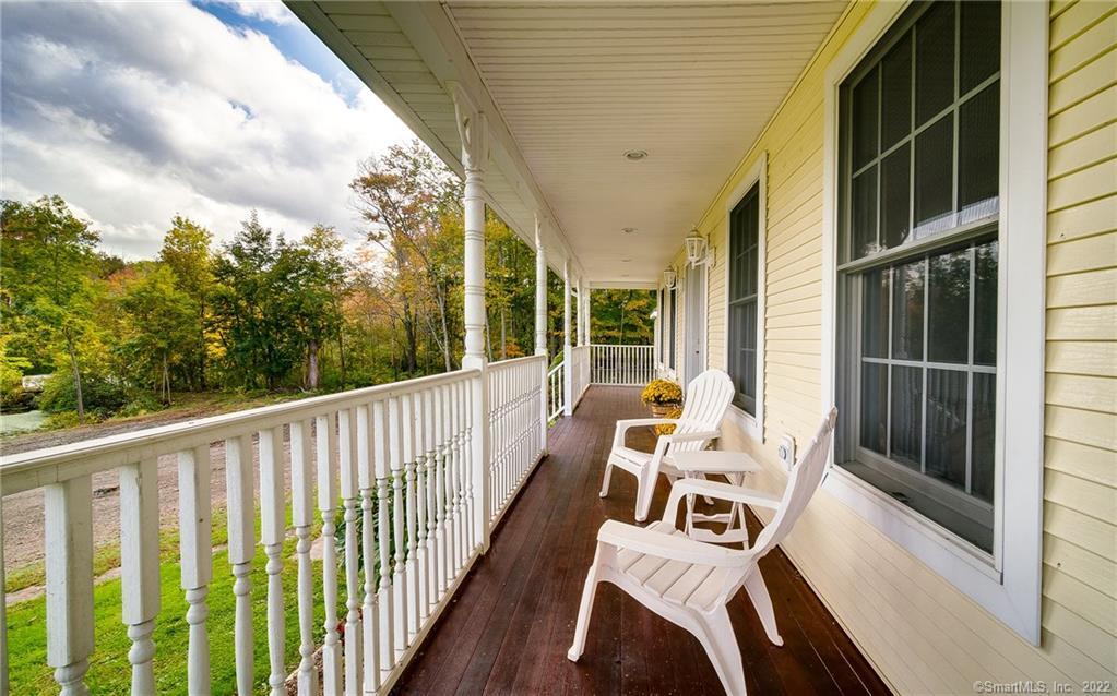 Front porch wraps around to mud room entrance and has mahogany floors