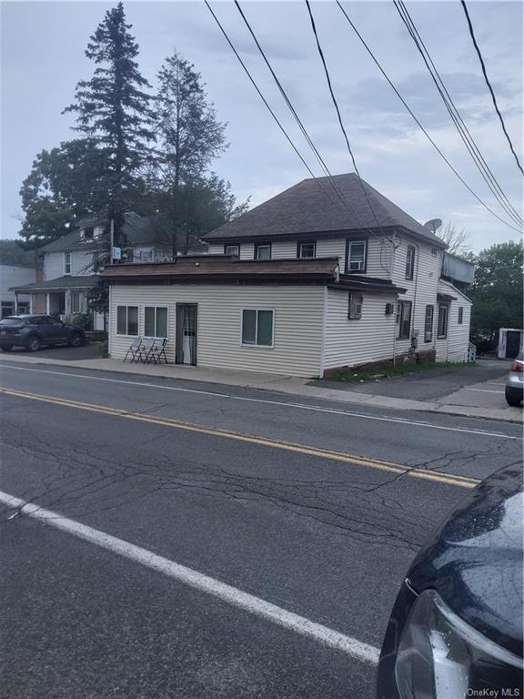 a front view of a house with a road