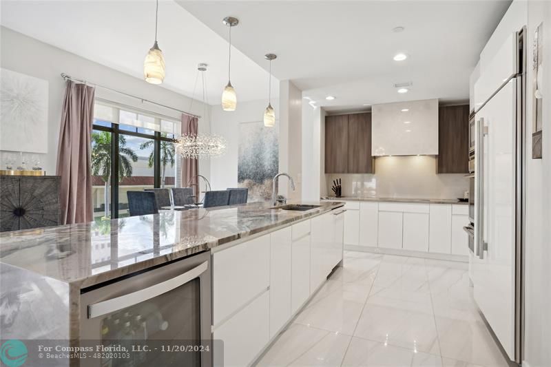 a large white kitchen with a large window