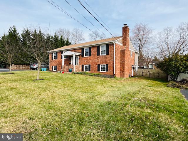 a front view of a house with a garden and trees