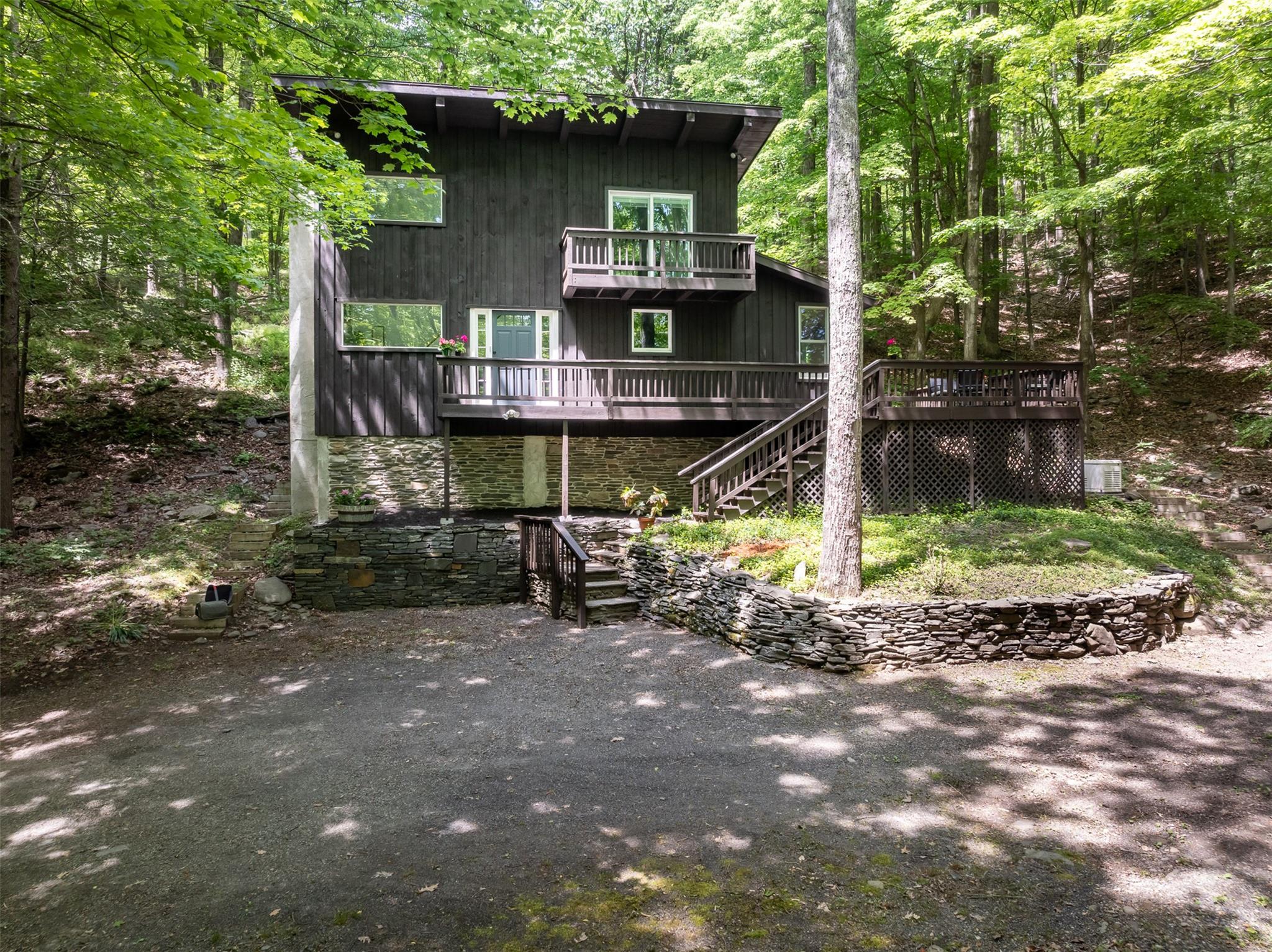 a view of a wooden house with a yard