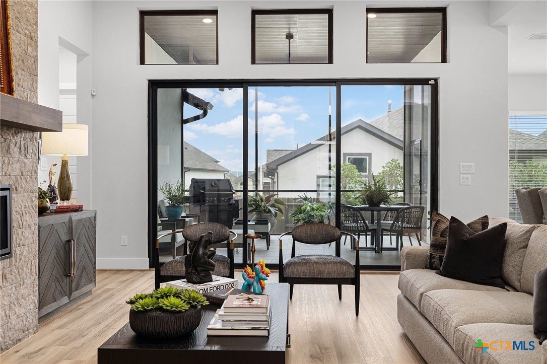 a living room with furniture and a floor to ceiling window