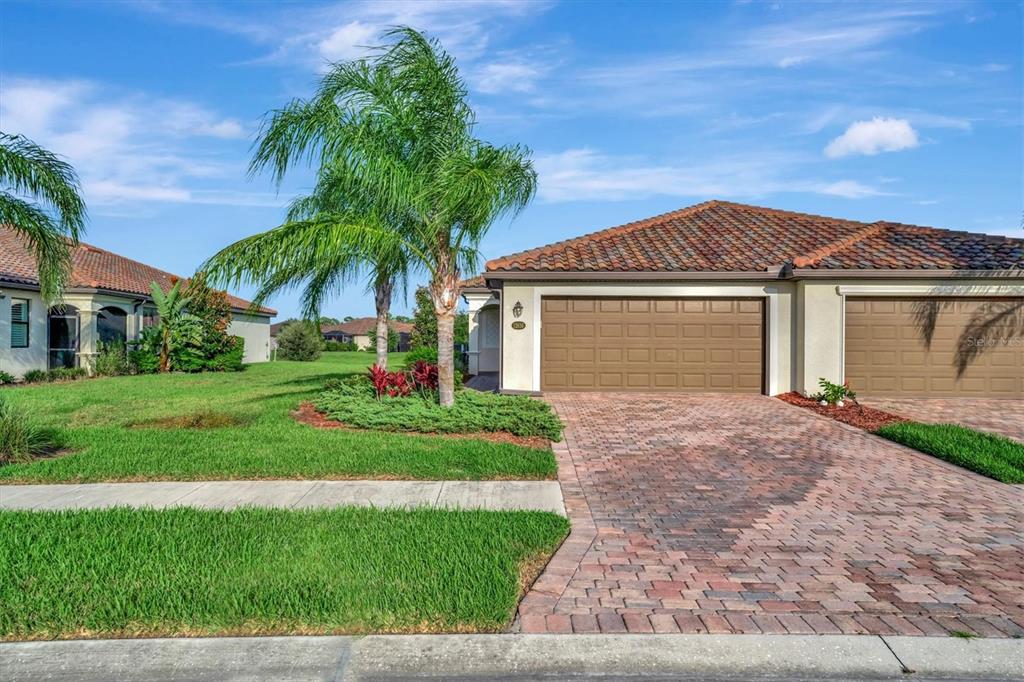 a front view of a house with a yard and garage