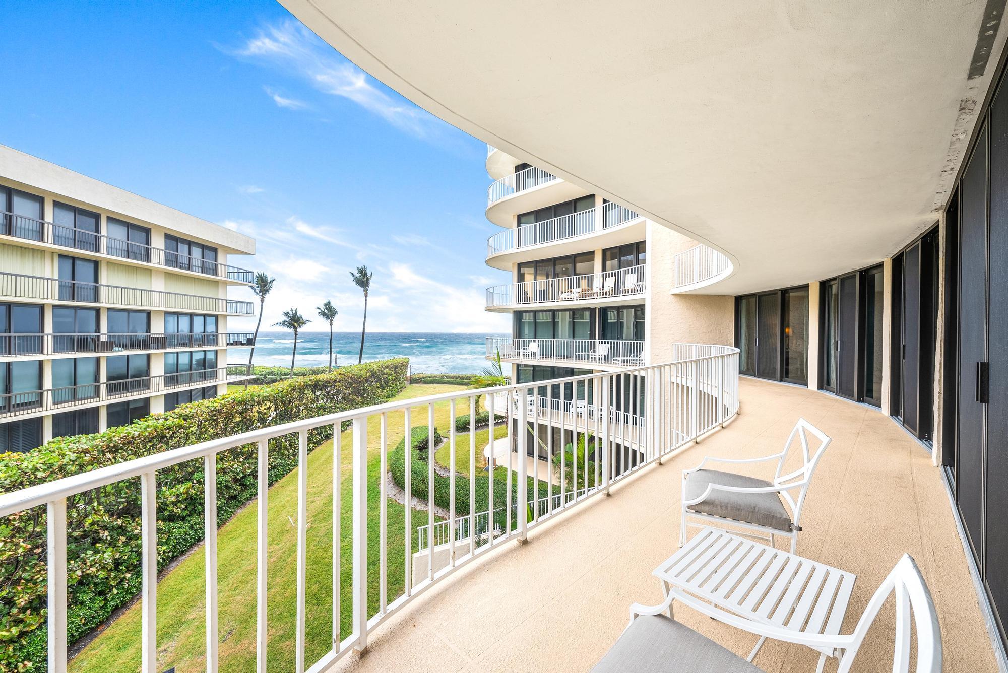 a view of balcony with wooden floor and fence