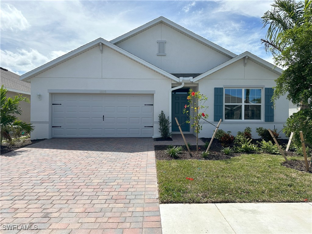 a front view of house with a garden