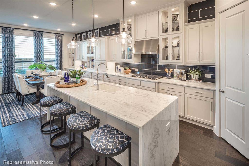 a large kitchen with a table and chairs