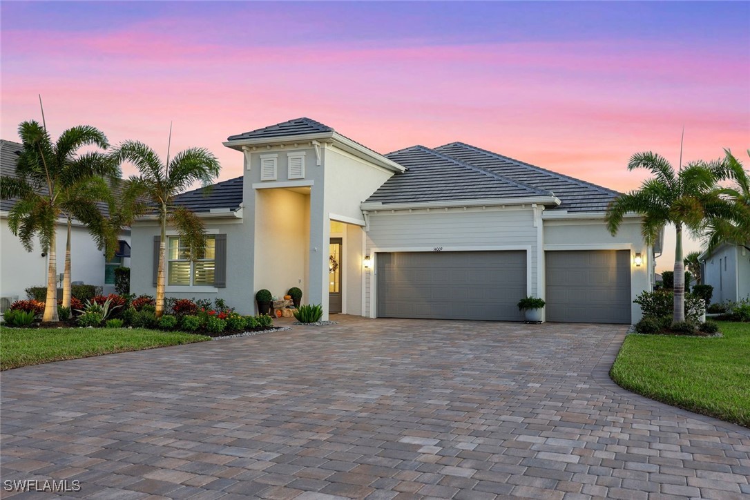 a front view of a house with a yard and garage