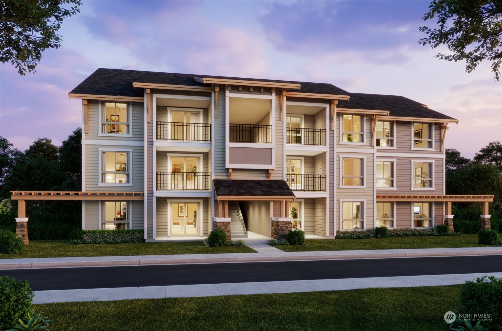 a front view of a residential apartment building with a yard