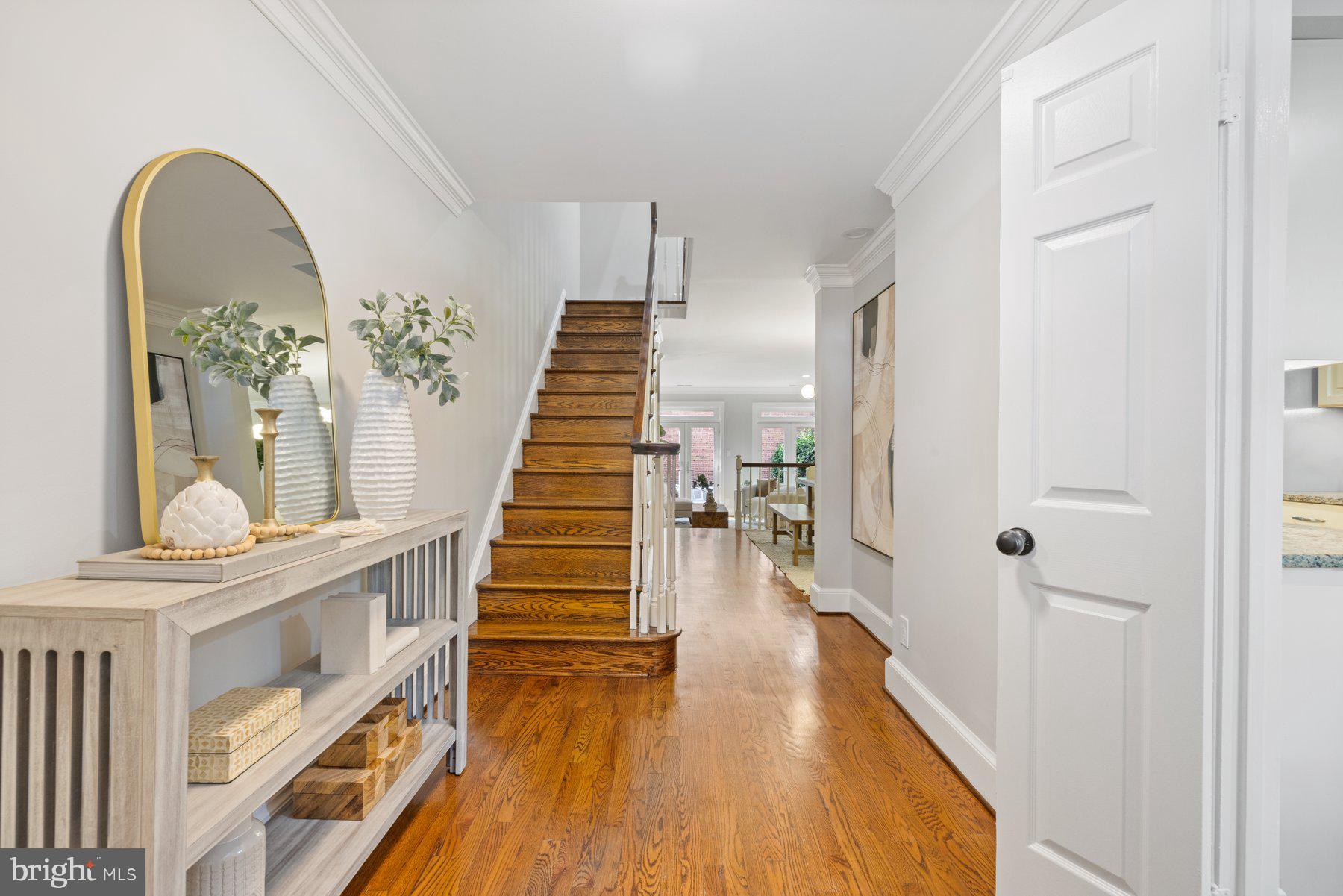 a view of a livingroom with wooden floor and stairs